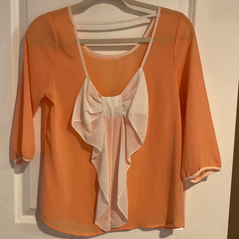Coral blouse with big white bow on back